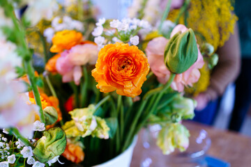 Bouquet of peony roses and tulips on the table in a vase