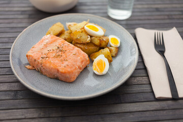 steamed salmon fillet with potato wedges and quail egg