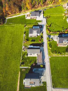 Vertical photo of four plots of land with newly build modern houses on it - New housing development 