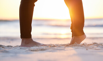 Couple at beach, legs and feet in sand with sunrise, love and commitment in relationship with...