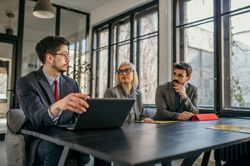 Human resource team talking and deciding who to hire application forms on a job interview in the...