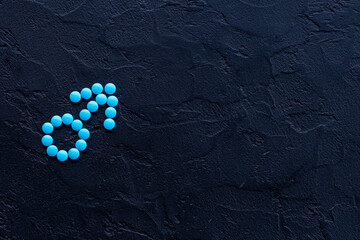 Male sign made of blue pills. Impotence concept. Mans health concept