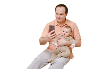 Man father and boy son take selfie photo on phone on sofa in home living room, isolated on a white background. Kid aged six months