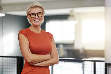 Portrait, arms crossed and smile of business woman in office with pride for career and job. Ceo glasses, boss face and happy, confident and proud elderly female entrepreneur from Canada in company.