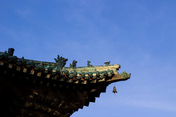 Fototapeta na wymiar Dashchoimbel Datsan Buddhist temple roof with carved decoration