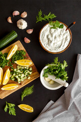 Bowl of dip sauce sour cream with herbs and garlic. Homemade dairy product background