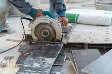 Worker use circular saw cutting plywood.