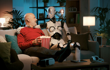 Senior man and caring robot watching movies together