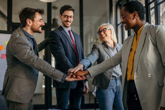 Happy Diverse Colleagues Team People Give Hands On Hands.  Business Teamwork Results Are Motivated By Business Success Victory Loyalty Unity Concept, Good Corporate Relations, And Team Building.