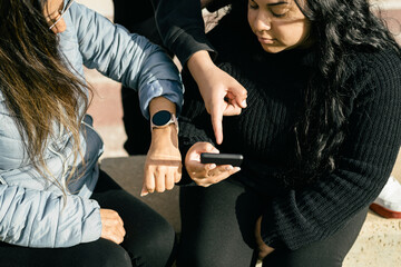 happy friends sharing multimedia content online with their smartphones and smartwatches