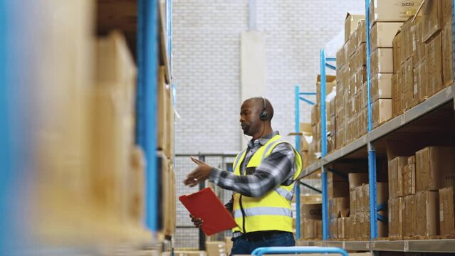 Order fulfillment and voice directed warehousing: Voice picker locates and collects boxes for shipping