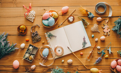 Easter background with Easter eggs and spring flowers. Top view with copy space.