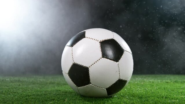 Close-up of Soccer Ball on Football Field, Rainy Weather. Super Slow Motion at 1000 fps. Filmed on High Speed Cinematic Camera.