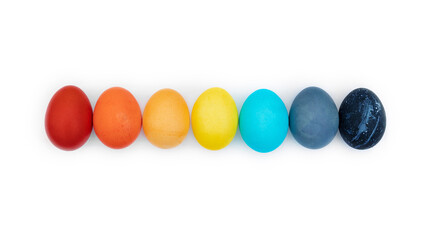 Easter multi-colored eggs laid out in a row isolated on a white background. Happy easter eggs painted rainbow colors close up photo with copy space. Graphic element for the decoration of Easter banner