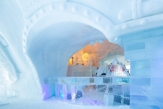St-Gabriel-de-Valcartier, Quebec, Canada, March 1, 2023 - The bar in the world-renowned seasonal Ice Hotel illuminated in blue and gold