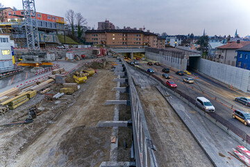 Traffic at highway enclosure construction site at City of Z&uuml;rich district Schwamendingen on a gray and cloudy winter evening. Photo taken March 1st, 2023, Zurich, Switzerland.