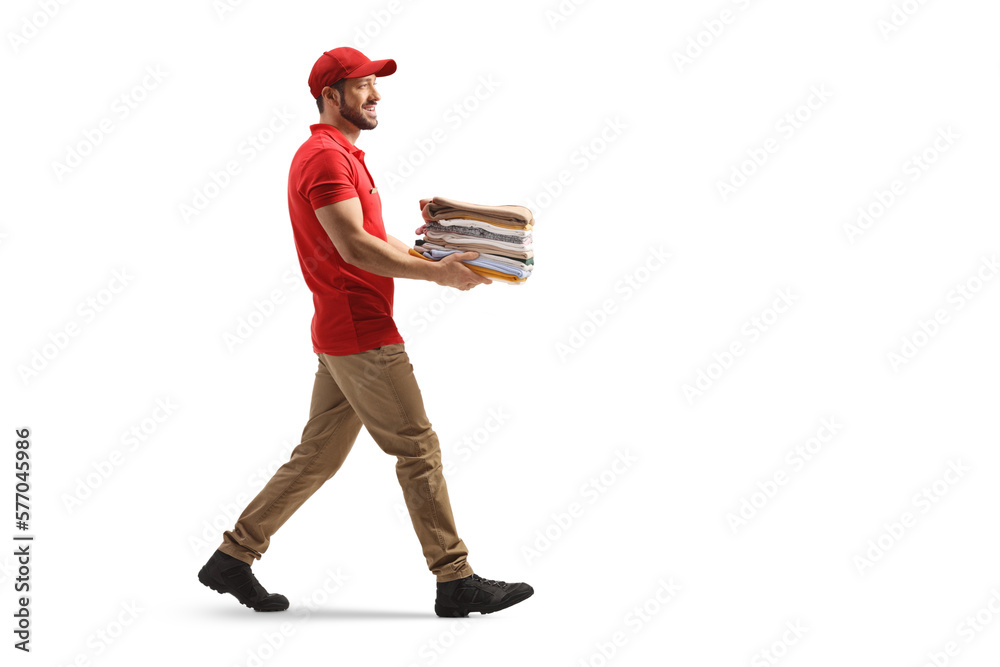 Poster Delivery man carrying a pile of folded clothes and walking