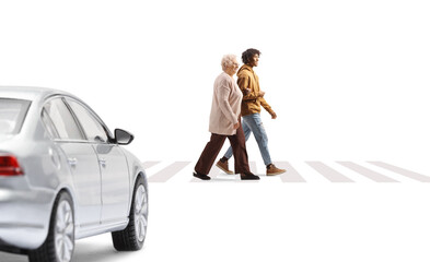 Young african american man helping a senior woman crossing a street