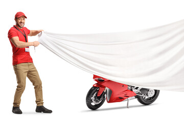 Salesman holding a big white cloth in front of a red racing motorbike