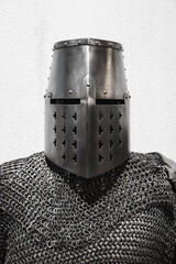 Medieval crusader knight armor, closed iron helmet and chain mail