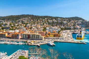 View of the main pier in the port of Nice. Many white yachts are moored near the water