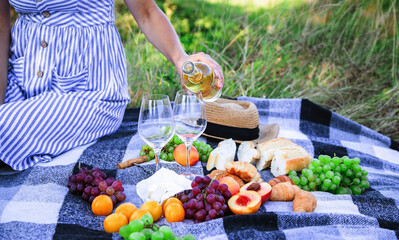 picnic in nature, girl pouring wine, couple in love. nature.