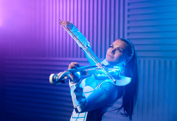 Fototapeta premium Portrait of violin solo player on stage in neon light