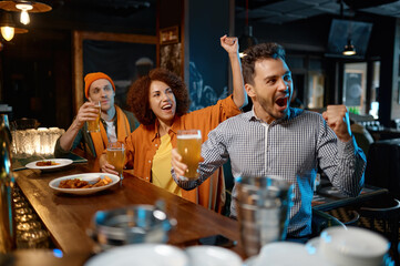 Excited football fans in the pub