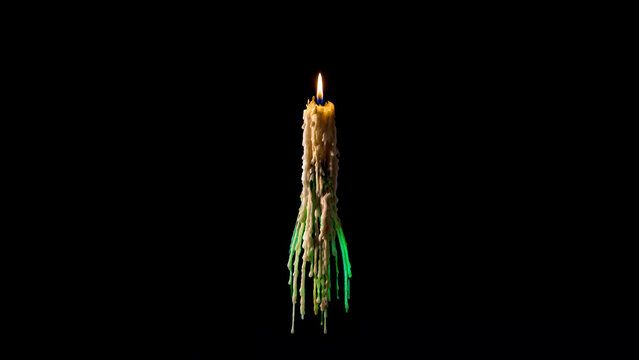 A burning floating fairy candle and molten wax in the dark. Black background. Copy space