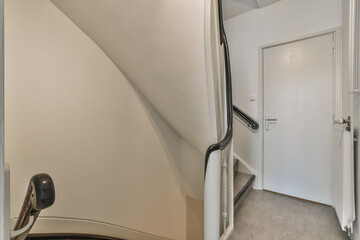 a room with a door in the corner and an open white door on the right side that leads to another room