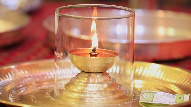 Point of view on arti diya being kept in transparent glass at the temple