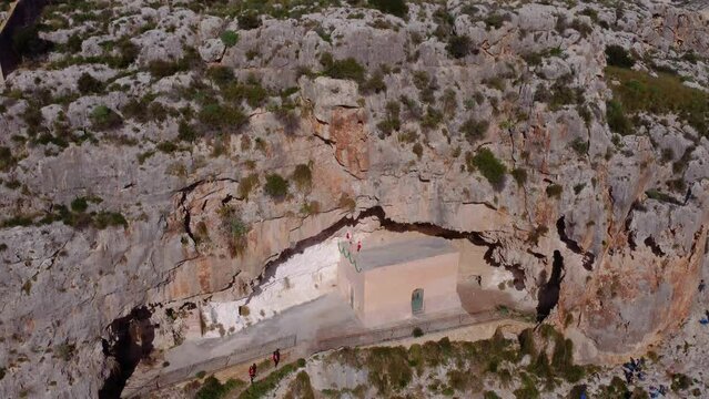 Drone shot of a small chapel in the middle of clifs of Valley of Honey in Mosta, Malta