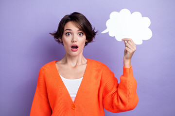 Photo of impressed speechless girl arm hold empty space cloud figure card open mouth isolated on...