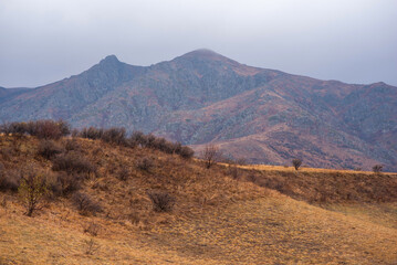 Amazingly beautiful autumn landscapes of a mountainous area located in northern China. Rainy landscape with clouds on top of mountains. Beautiful non-tourist routes. Exploring new places.