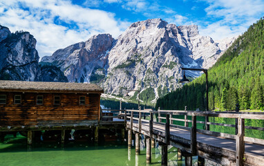 Fototapeta na wymiar Braies Lake in Dolomites mountains forest on the background. The lake is surrounded by forest which are famous for scenic hiking trails. Mountain landscape, lake and mountain range.