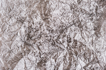 Crumpled white paper colored with black pencil. Texture.