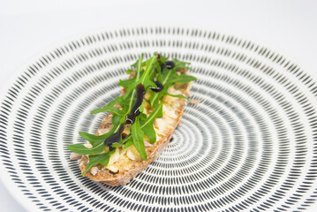 Delicious breakfast. Snack with rucola and cheese.