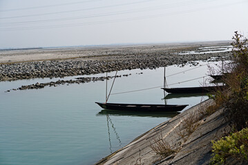 wooden boat floating in the river water