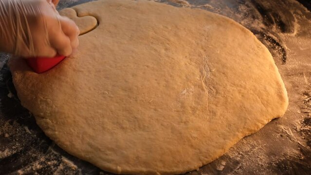 the chef prepares shortbread cookies in the shape of a heart