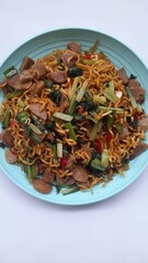fried noodles with mixed mustard greens on a plate top view against a white background. healthy food background concept, food recipe, restaurant, breakfast, lunch, dinner, traditional food, lifestyle