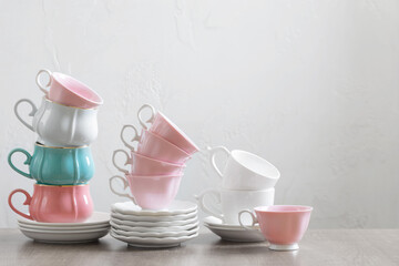 group of different cups on wooden table on white background