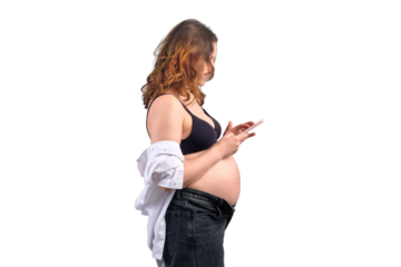 A pregnant woman with a phone in her hands, isolated on a white background