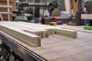 Shallow focus view of lumber cut for joining frames in an old-fashioned workshop