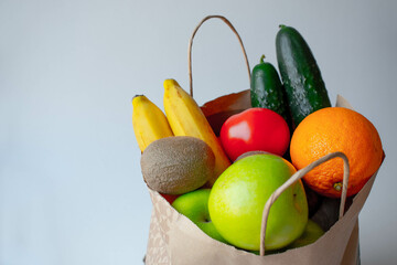 Healthy Food Background. Healthy vegan vegan food in paper bag fruits and vegetables on white, copy...