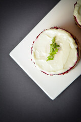 Top view of Traditional holiday layered fish salad Herring under fur coat served in culinary rings. Copy space image with text space. Russian salad with beetroot, potato, onion, fish and mayonnaise