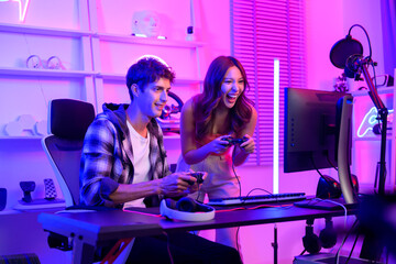 Young professionals  play video games together live streaming their matches  and speak with their fans at  homes. © tonefotografia