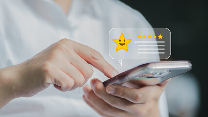 close up Woman hand using smart phone and give five star symbol to increase rating of product and service concept, Customer service experience and business satisfaction survey.