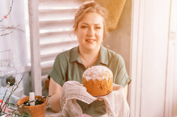 happy easter holiday time in spring season. beautiful young housewife woman holds a freshly baked...