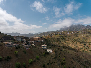 Fototapeta premium Aerial photos of Assomada in Santiago Island, Cabo Verde, reveal the vibrant culture, colorful markets, and stunning mountain landscapes of this historic town. The bird's-eye view captures the essence