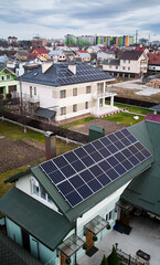 Modern houses with photovoltaic solar panel modules on rooftop. Houses, residential buildings and homes with solar electric system in new neighborhood. Renewable energy concept. © anatoliy_gleb